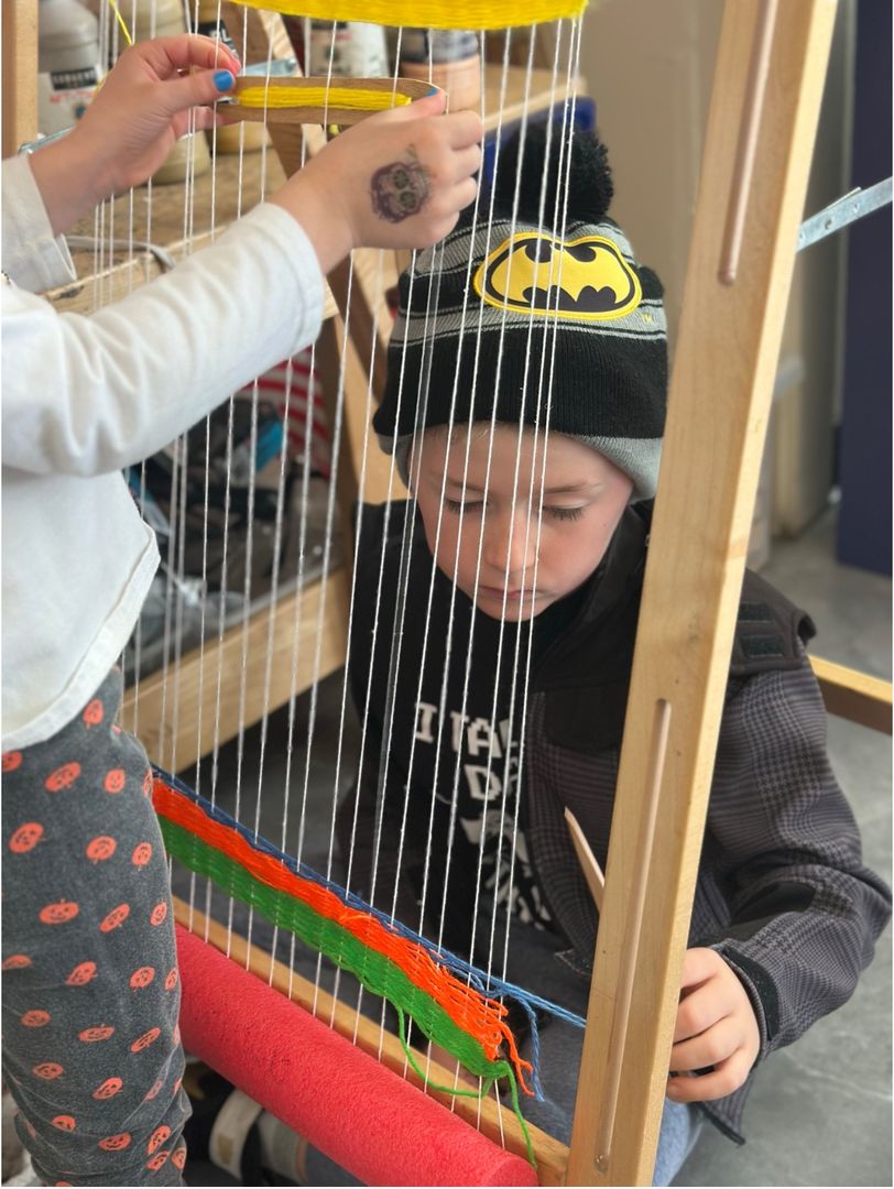 Hudson School students weaving on looms at the Lower School campus