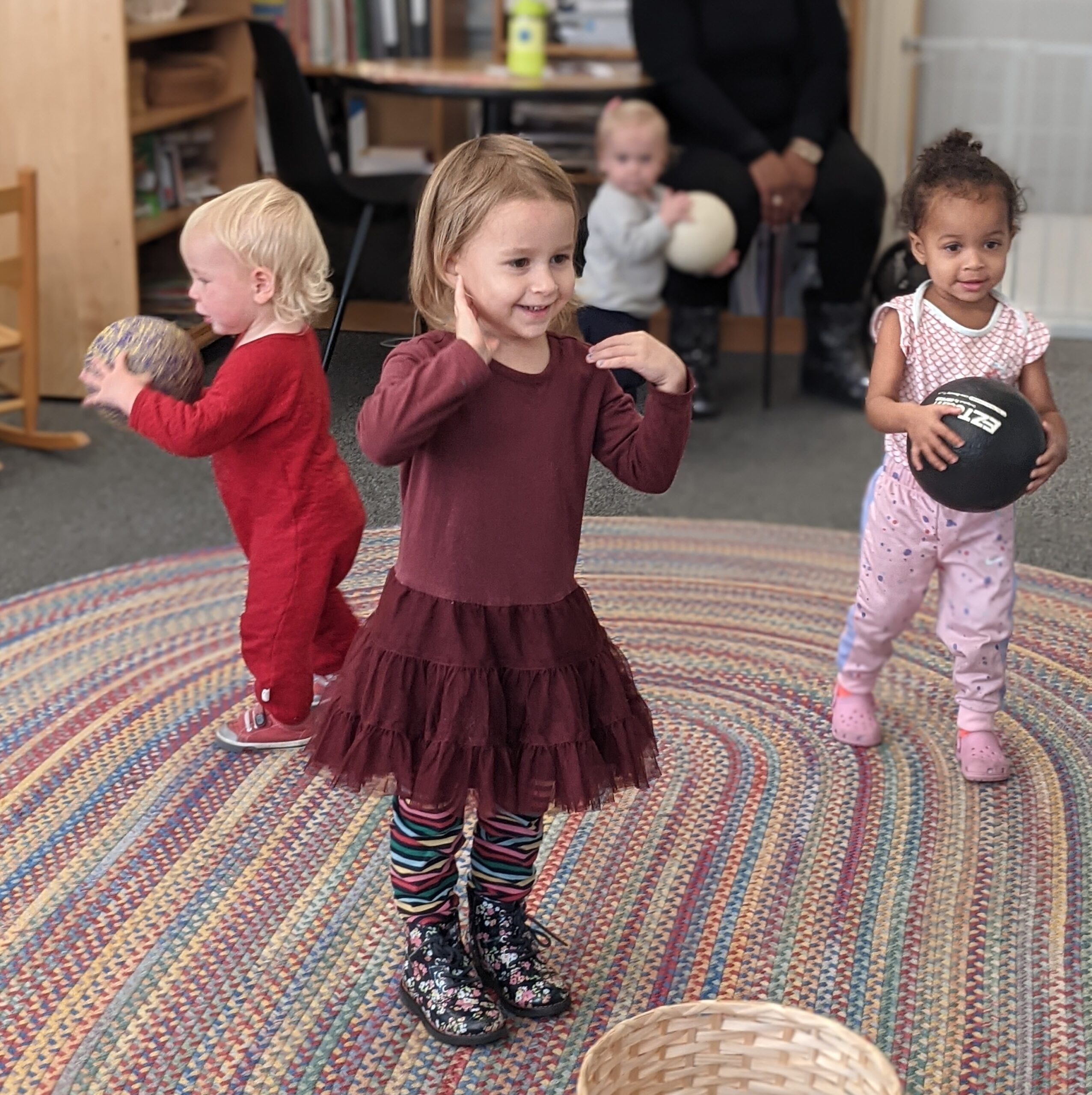 Toddlers playing together during circle time in a Hudson School classroom