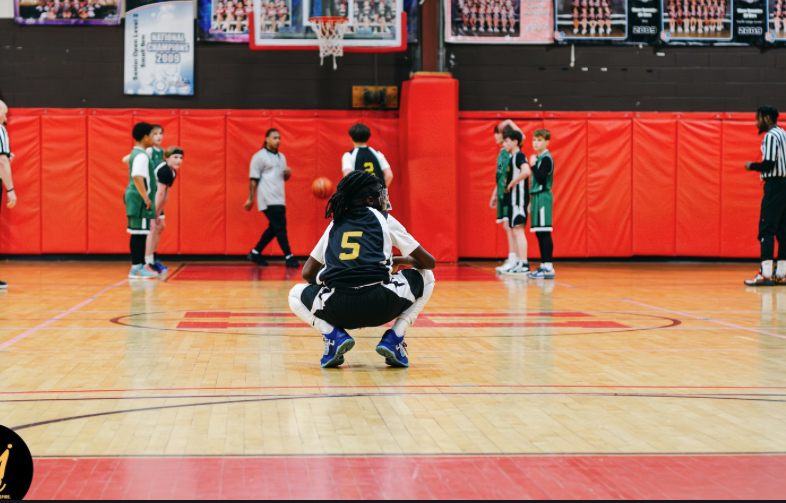 A Hudson middle school player brings the ball up court during a basketball game