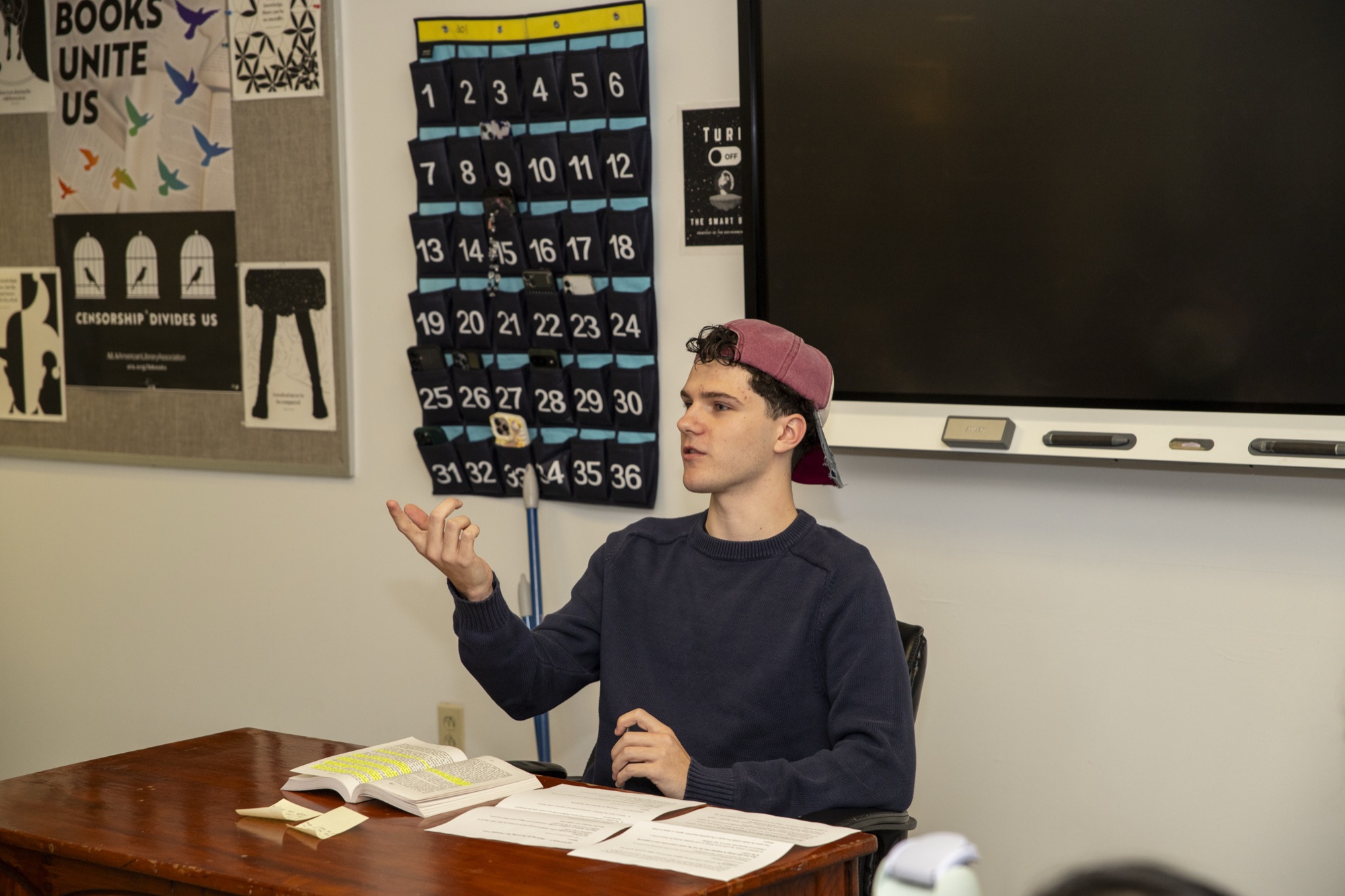 Two teenage students in conversation at a Hudson School studio table
