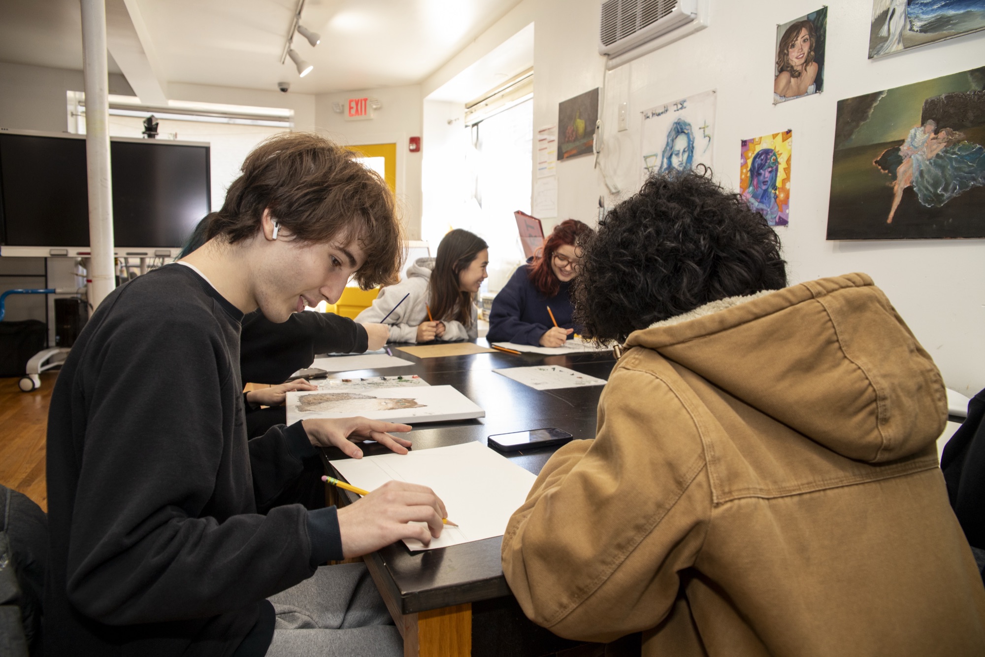 High school students collaborating on art projects in the Hudson studio