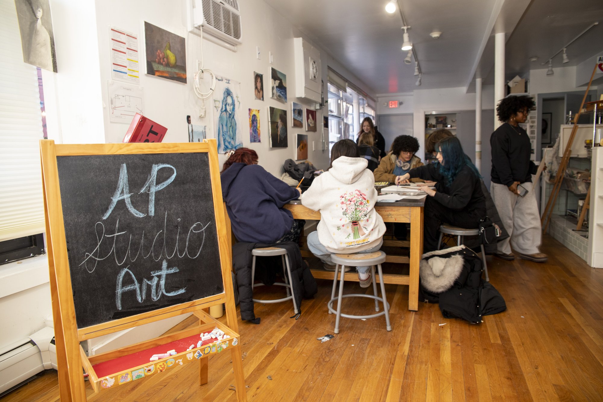 Students working with their teacher in the AP Studio Art classroom