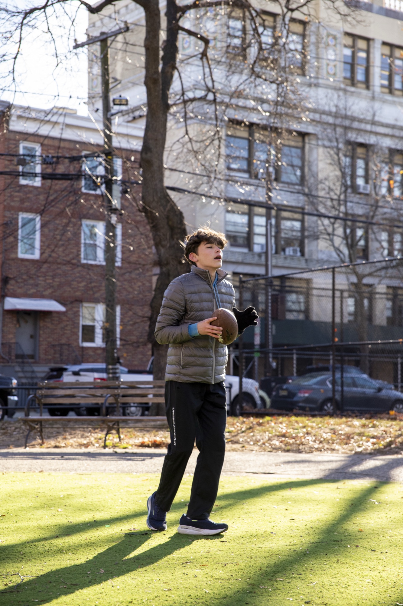 Hudson School student athlete leaping mid-air in an urban park setting