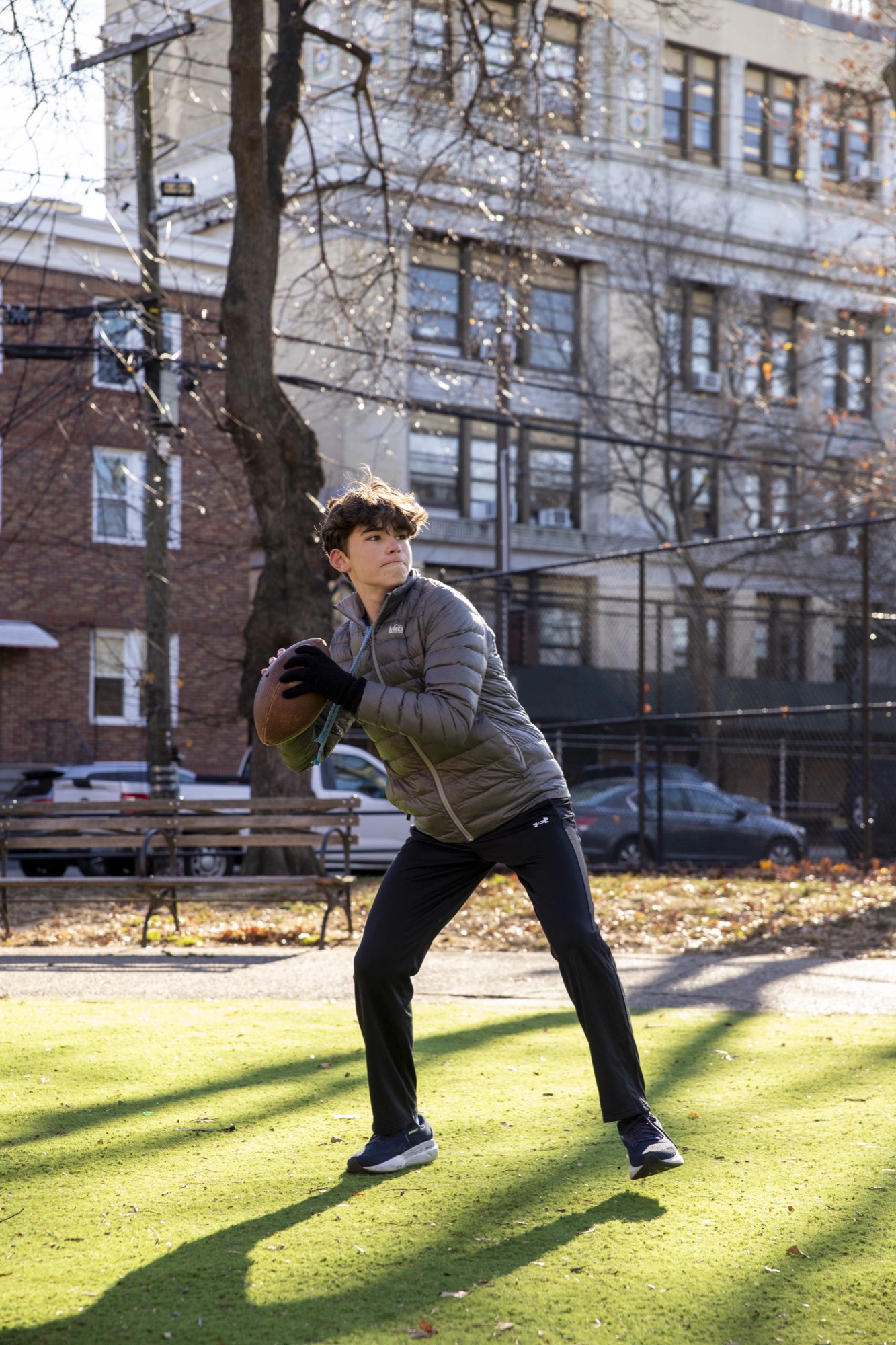 Hudson student-athlete jumping high above a park green