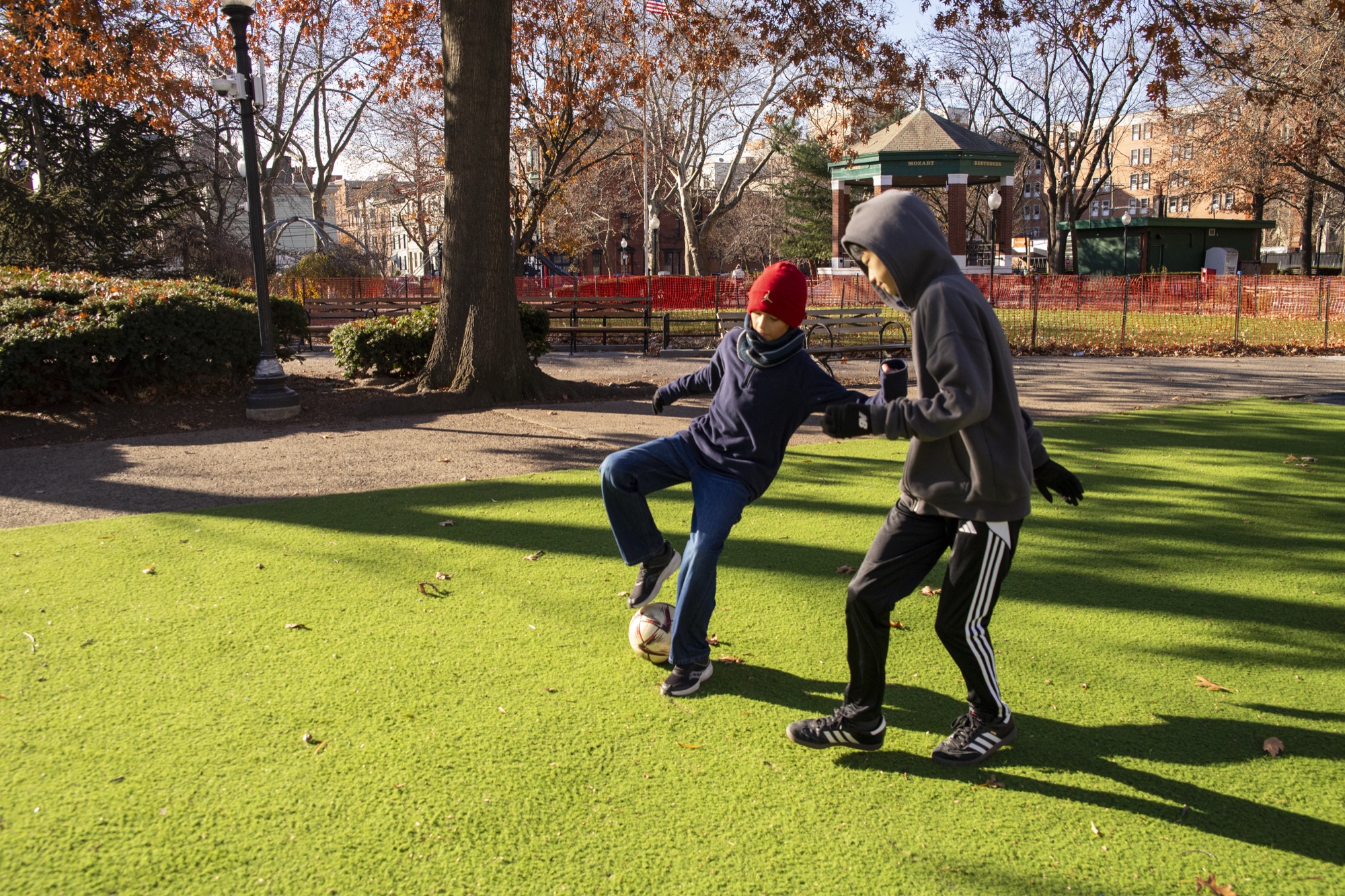 Hudson School student running across an outdoor urban park field