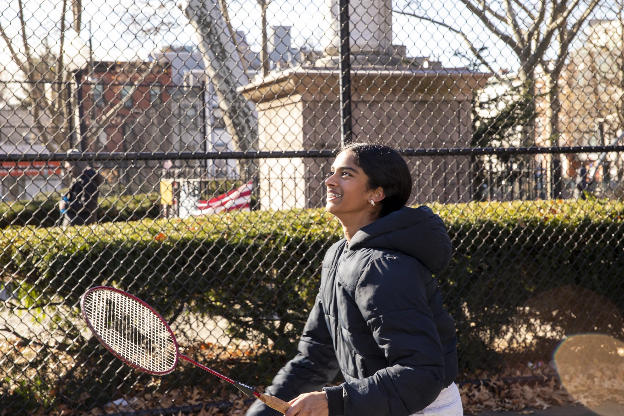 Female student walking at outdoor basketball court