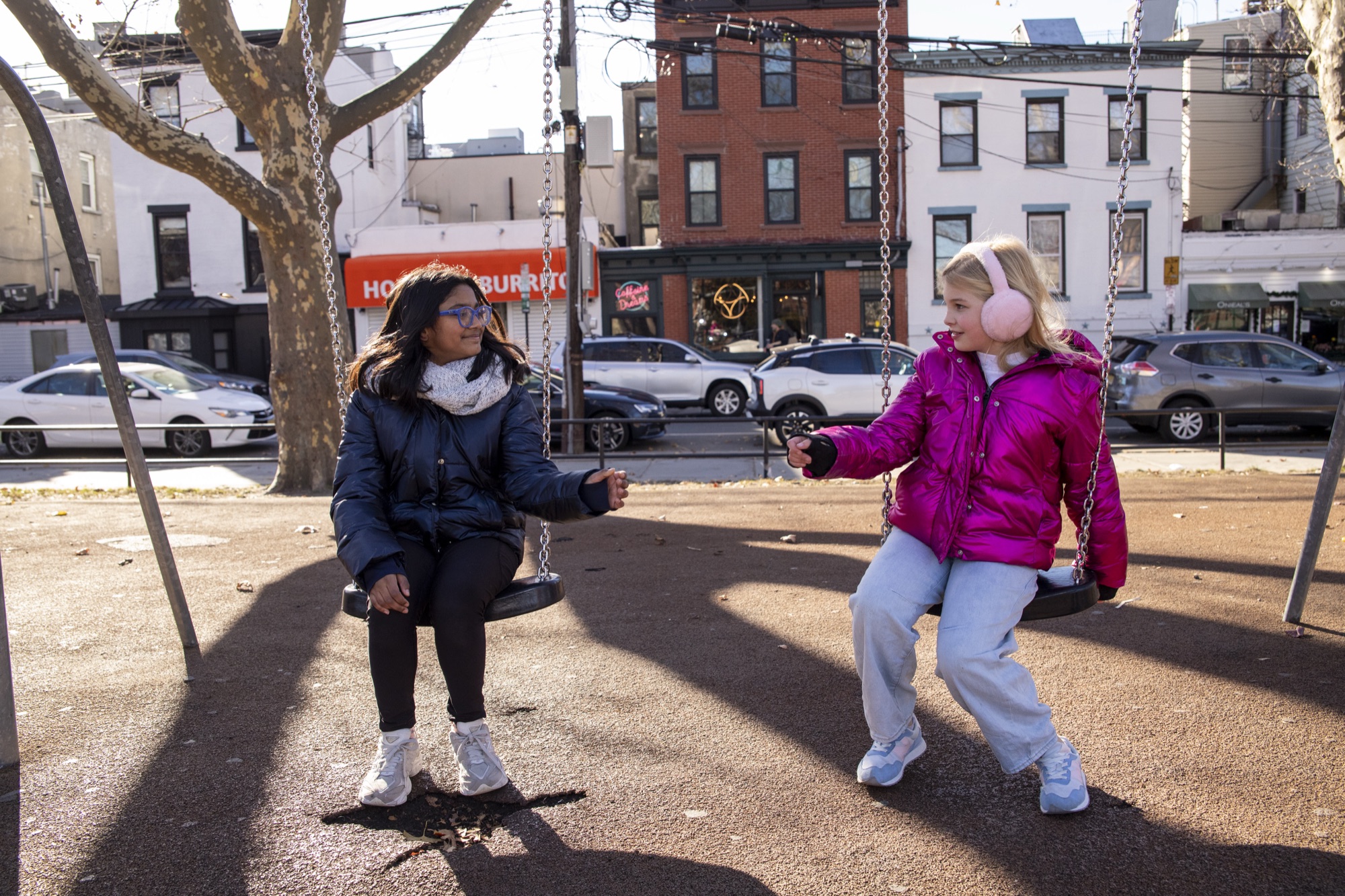 Young students jumping rope in front of Hoboken brownstones