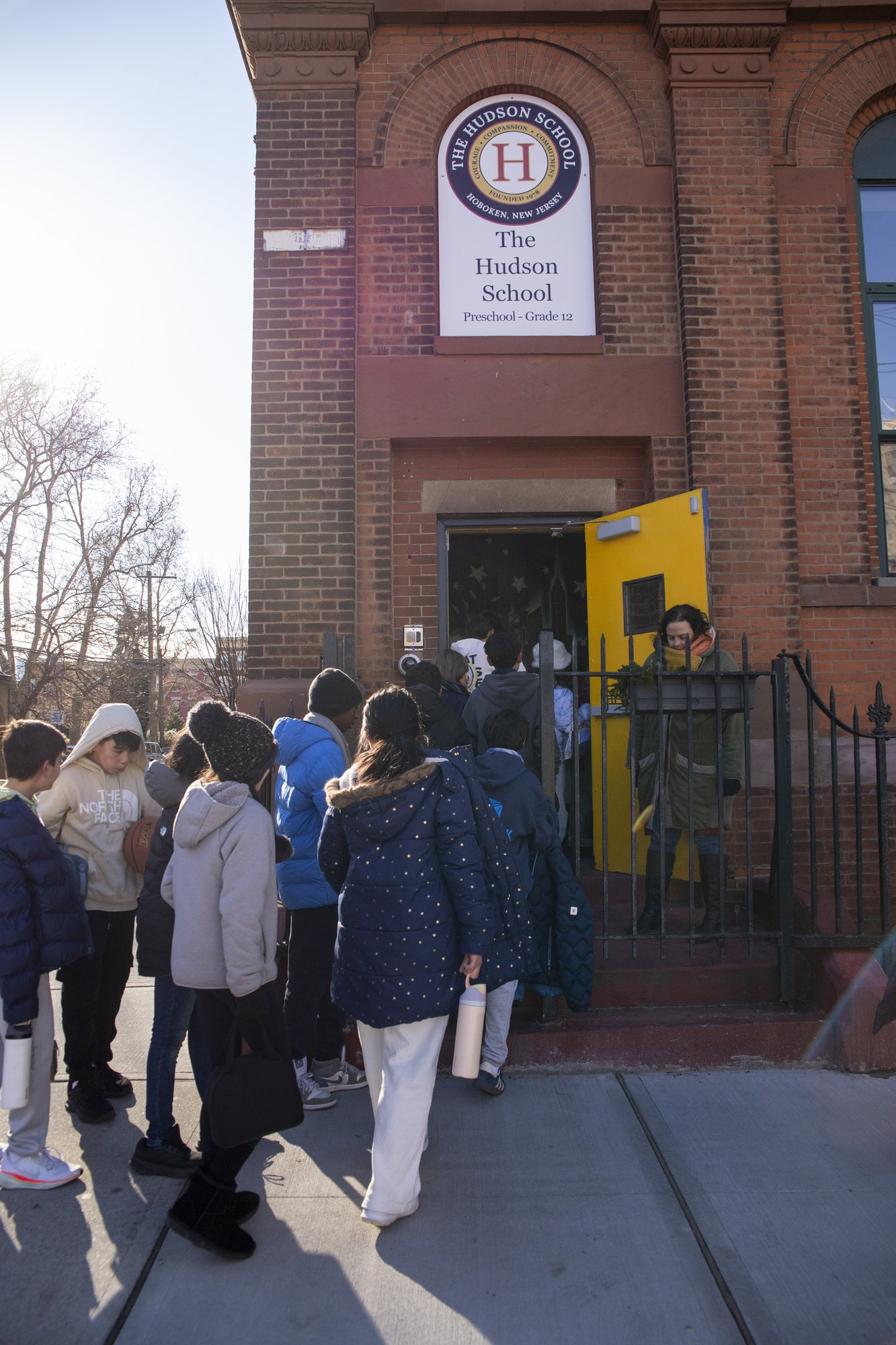 Red brick school exterior stop sign and entrance
