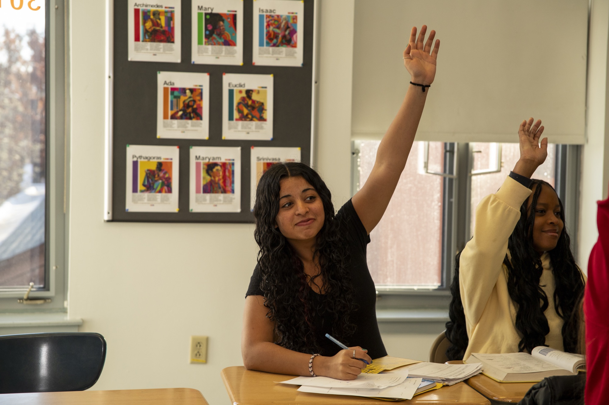 Hudson Upper School student posing energetically in a classroom hallway