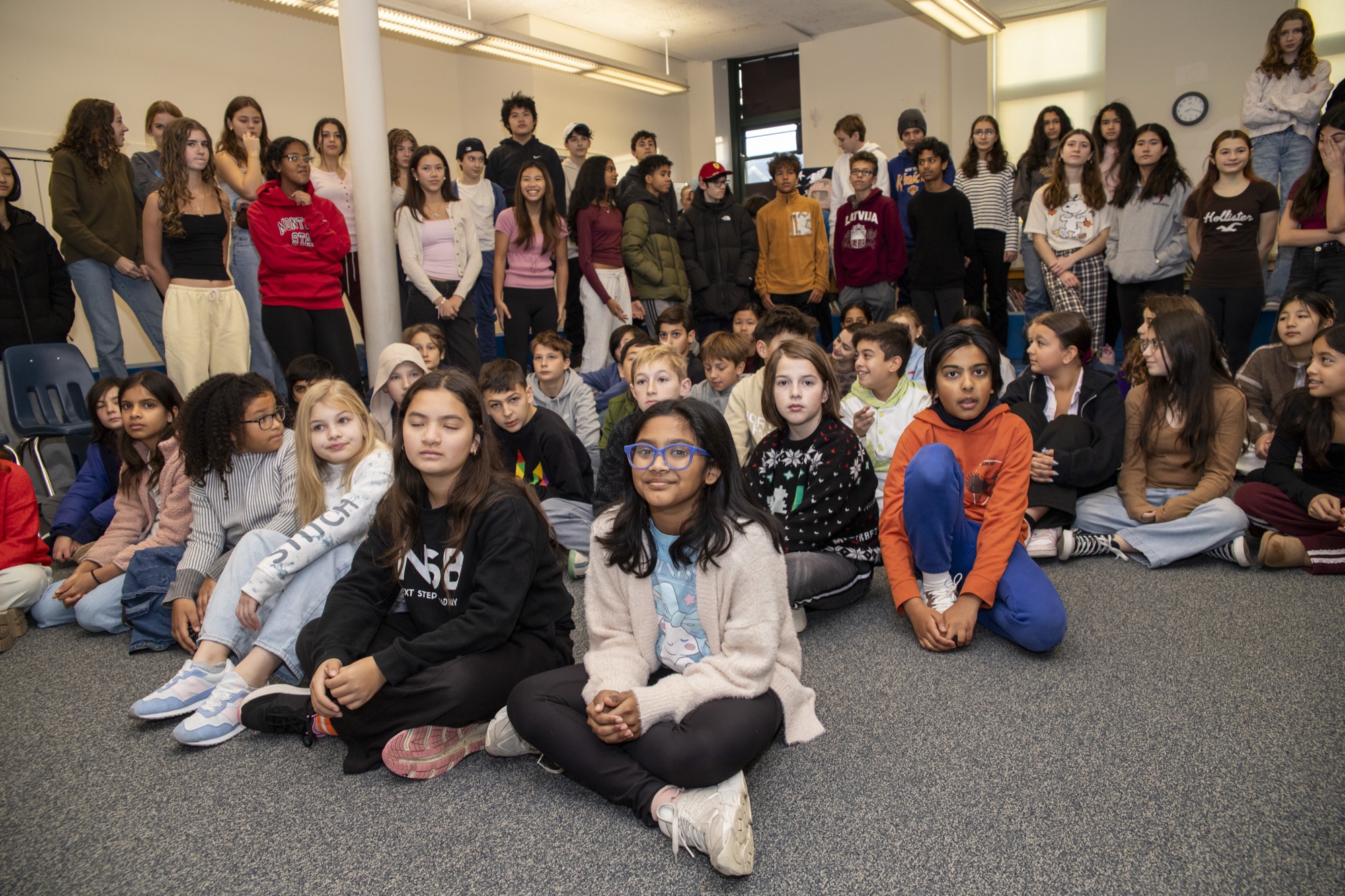 Students and community members seated together at a Hudson School assembly