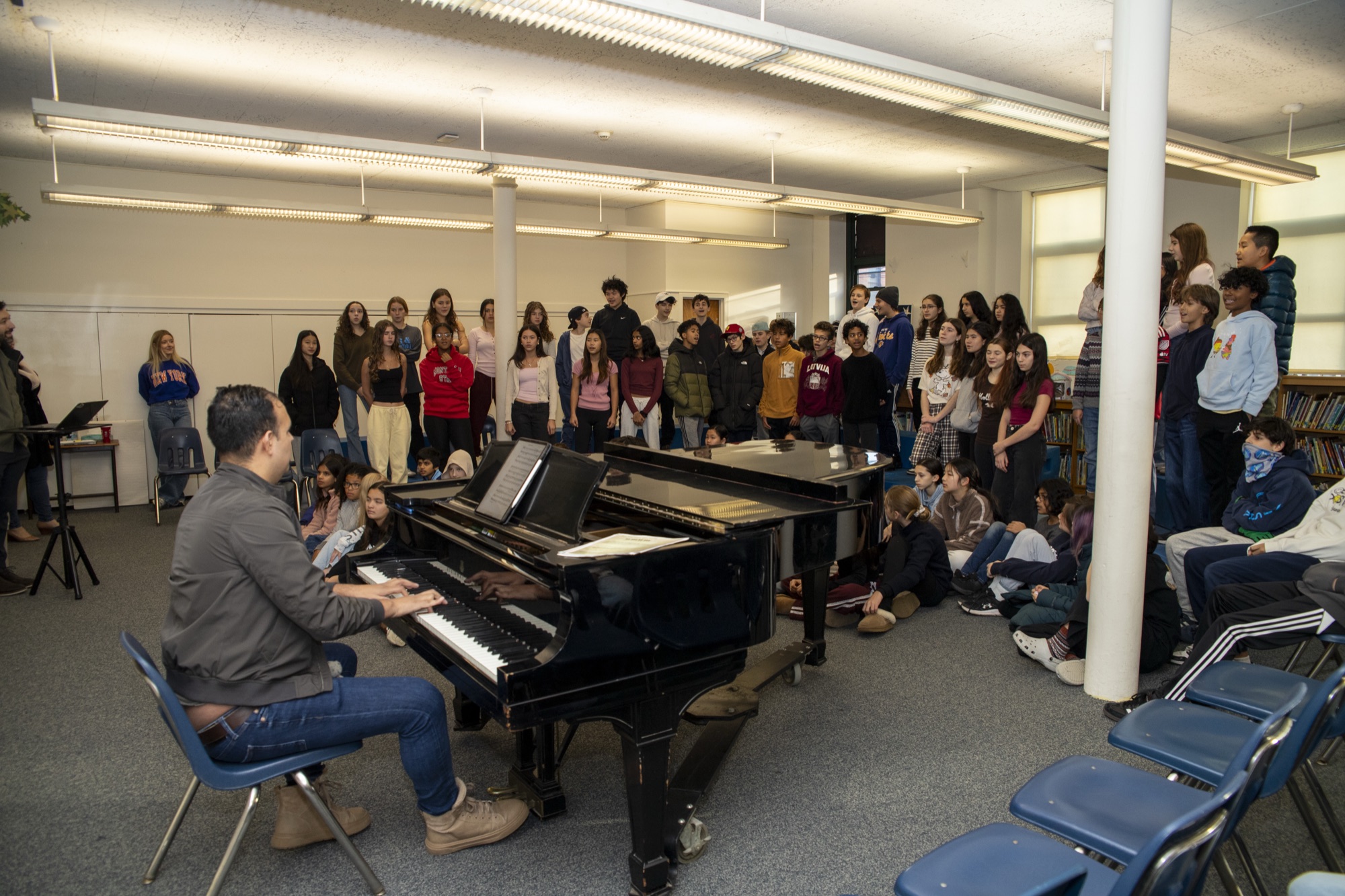 Hudson students in close view of choir or assembly in tiered seating
