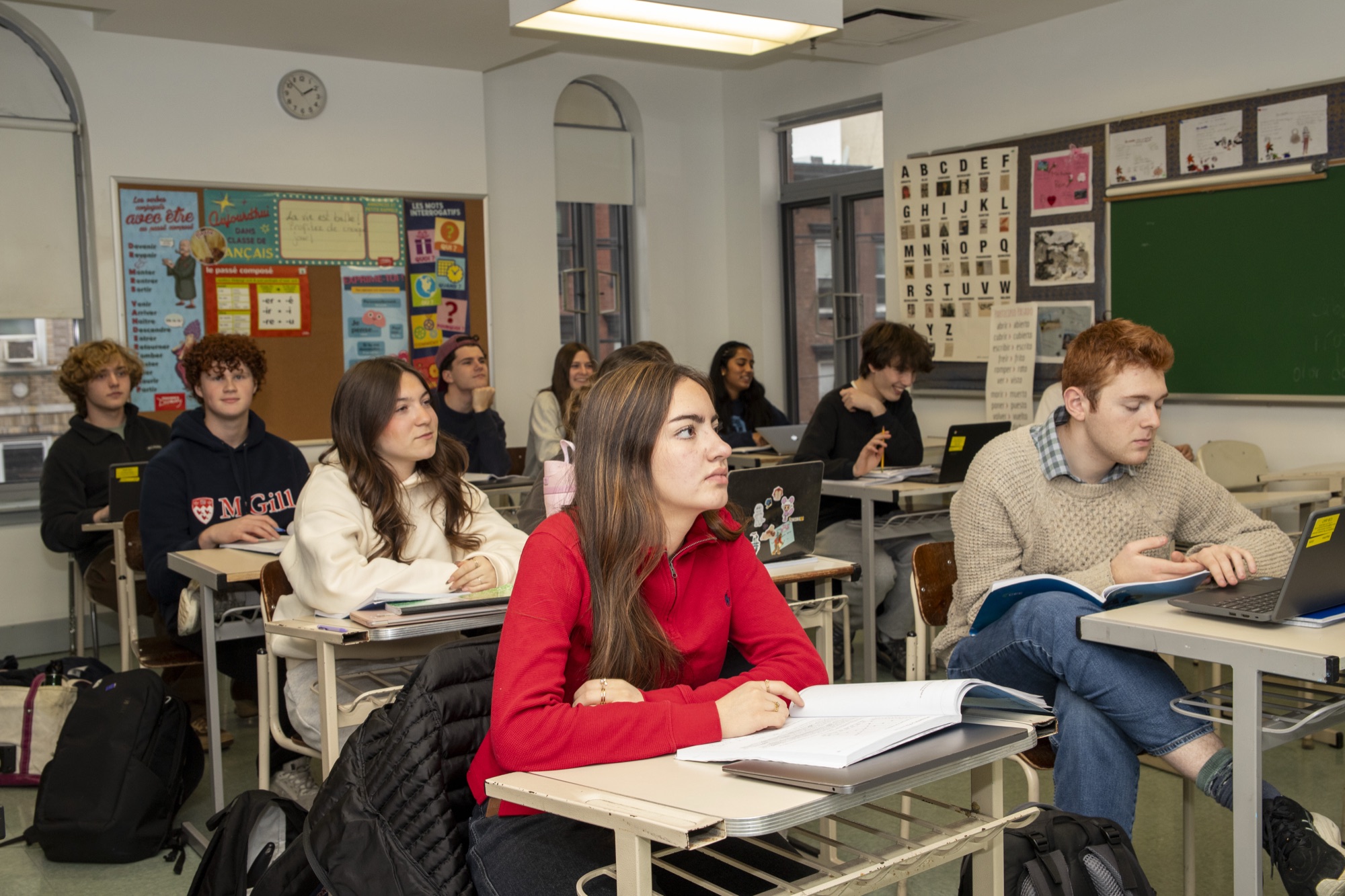 High school students in engaged discussion around a classroom table