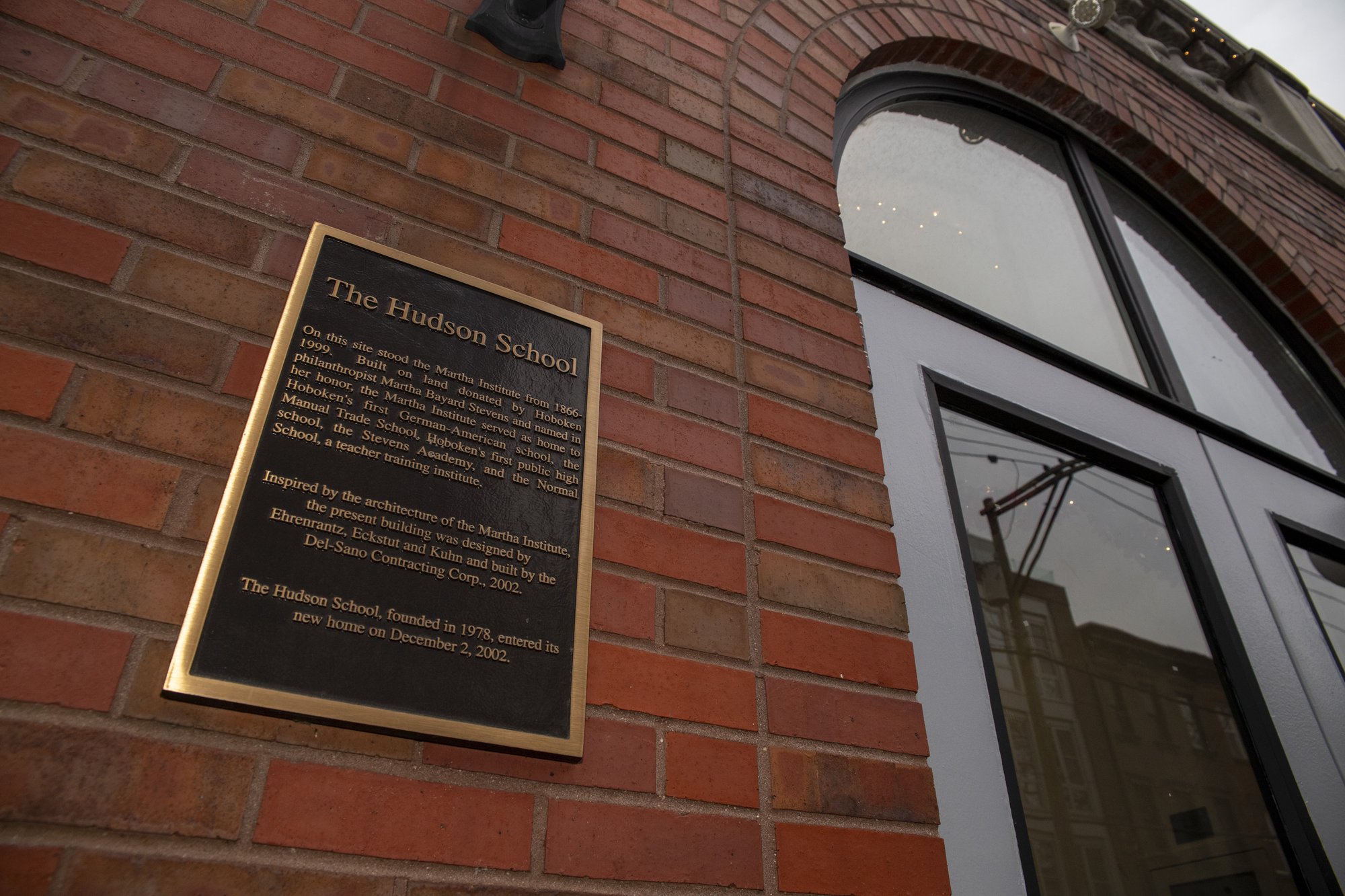 Bronze plaque reading The Hudson School on the brick facade of the 601 Park Avenue building