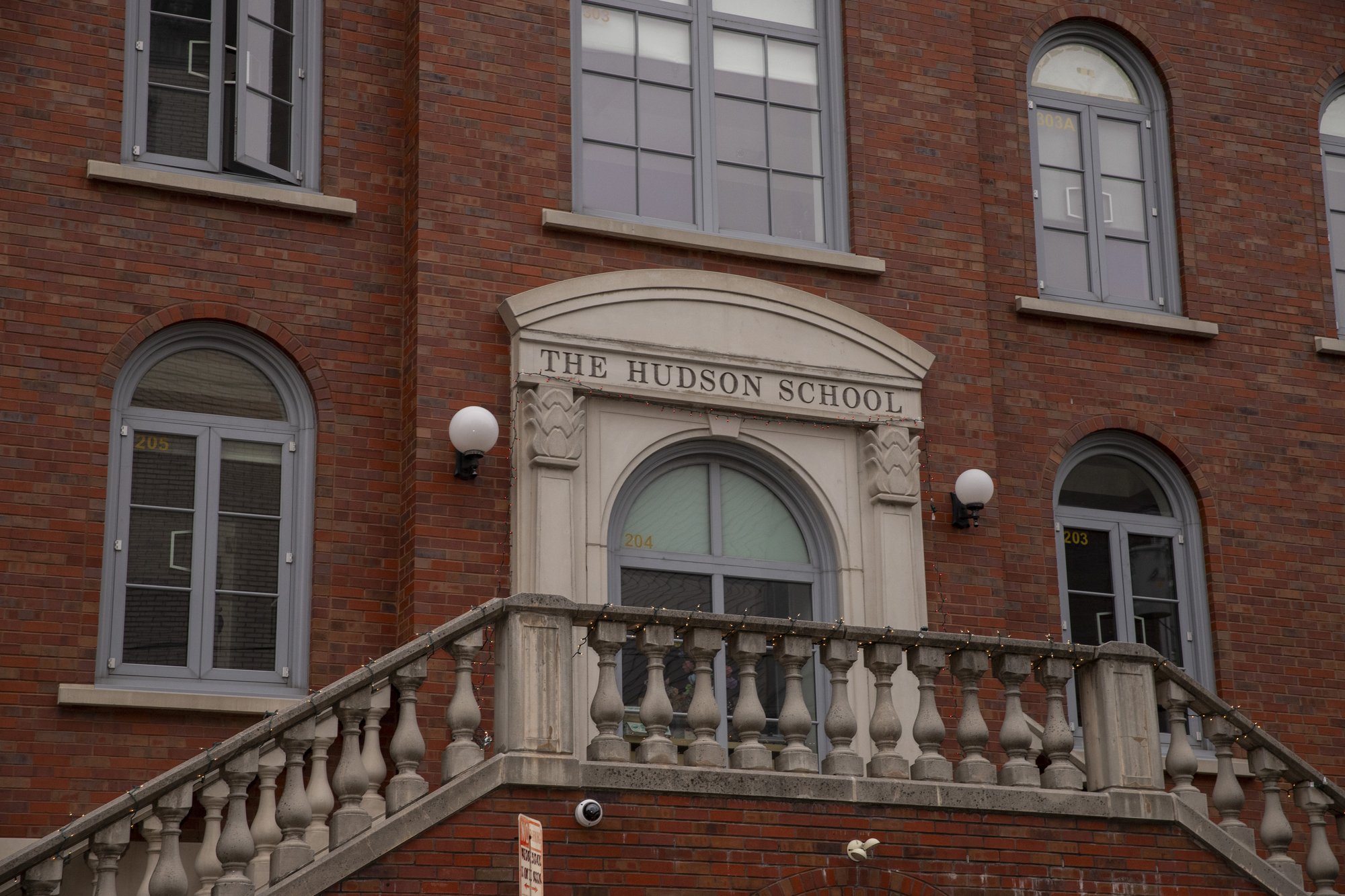 The Hudson School main entrance with stone staircase and arched windows