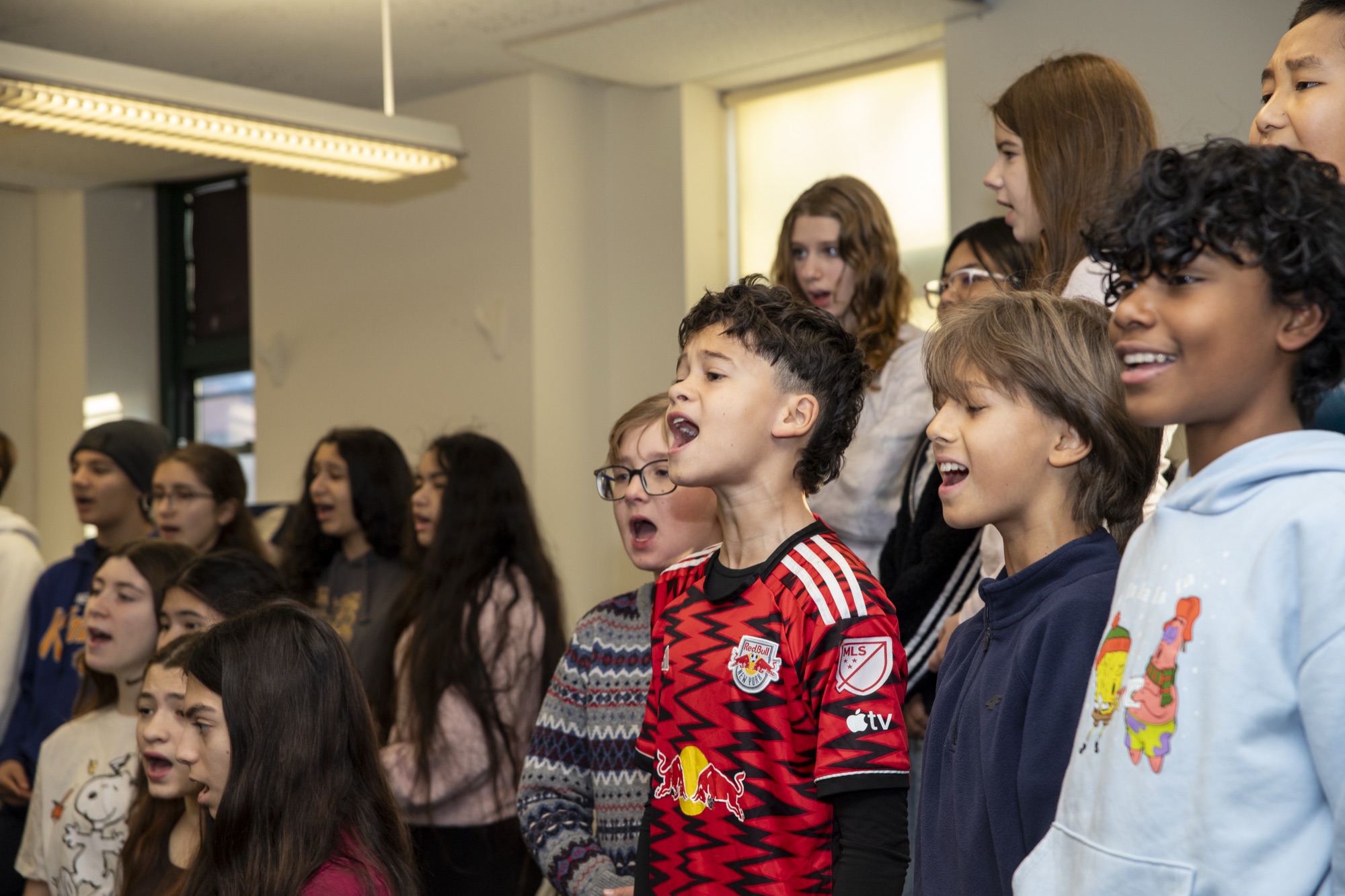A diverse group of Hudson School students smiling at the camera