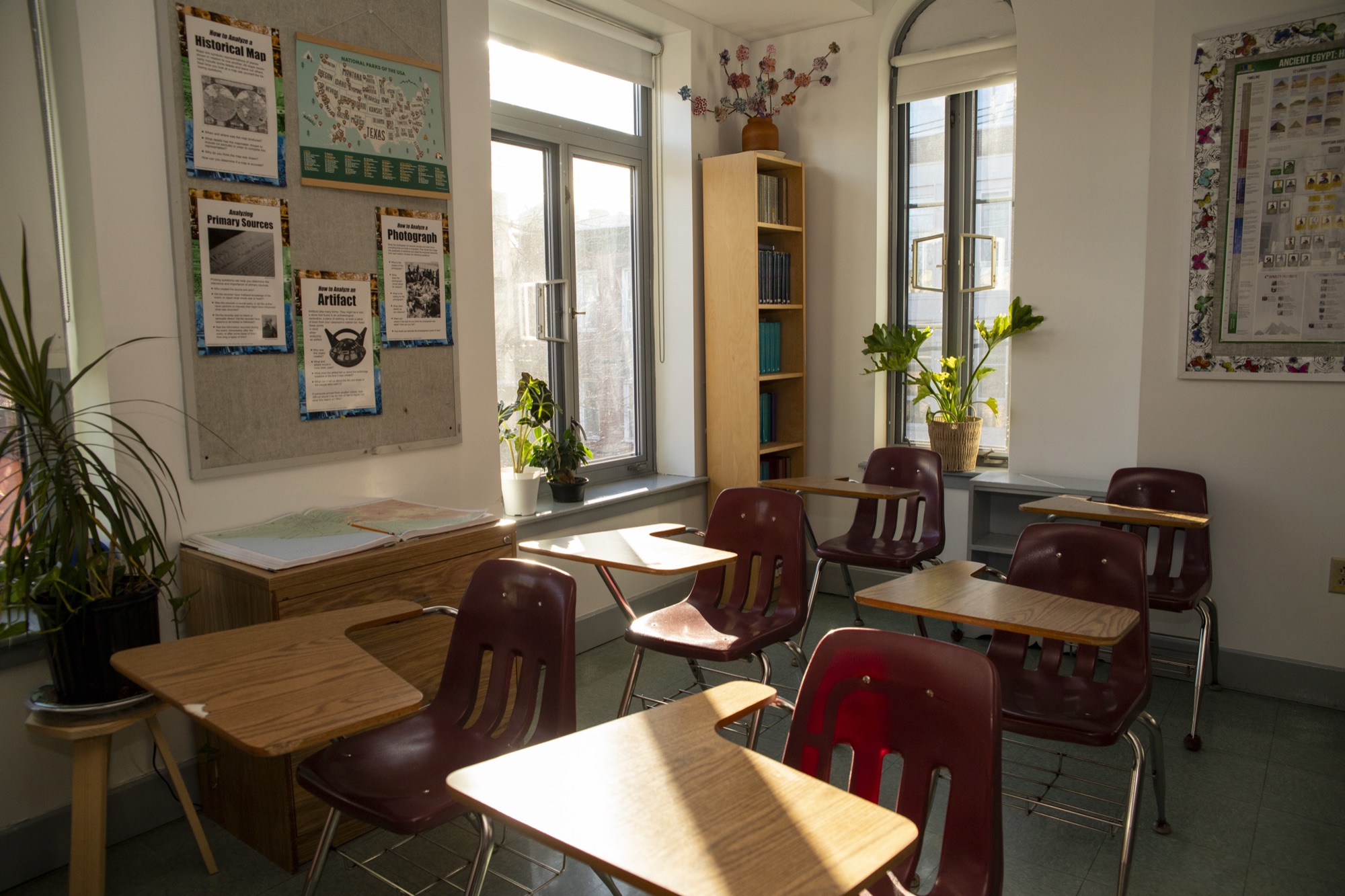 Sunlit empty Hudson School classroom with bookshelves along the walls