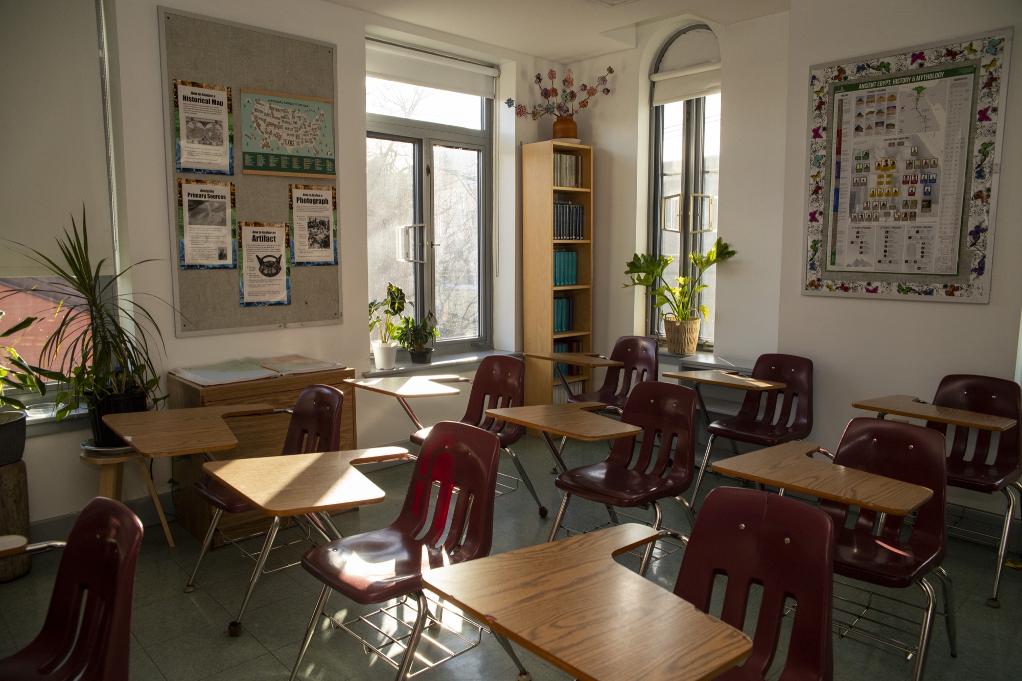 A female student at a desk in a beautiful sunlit Hudson School classroom