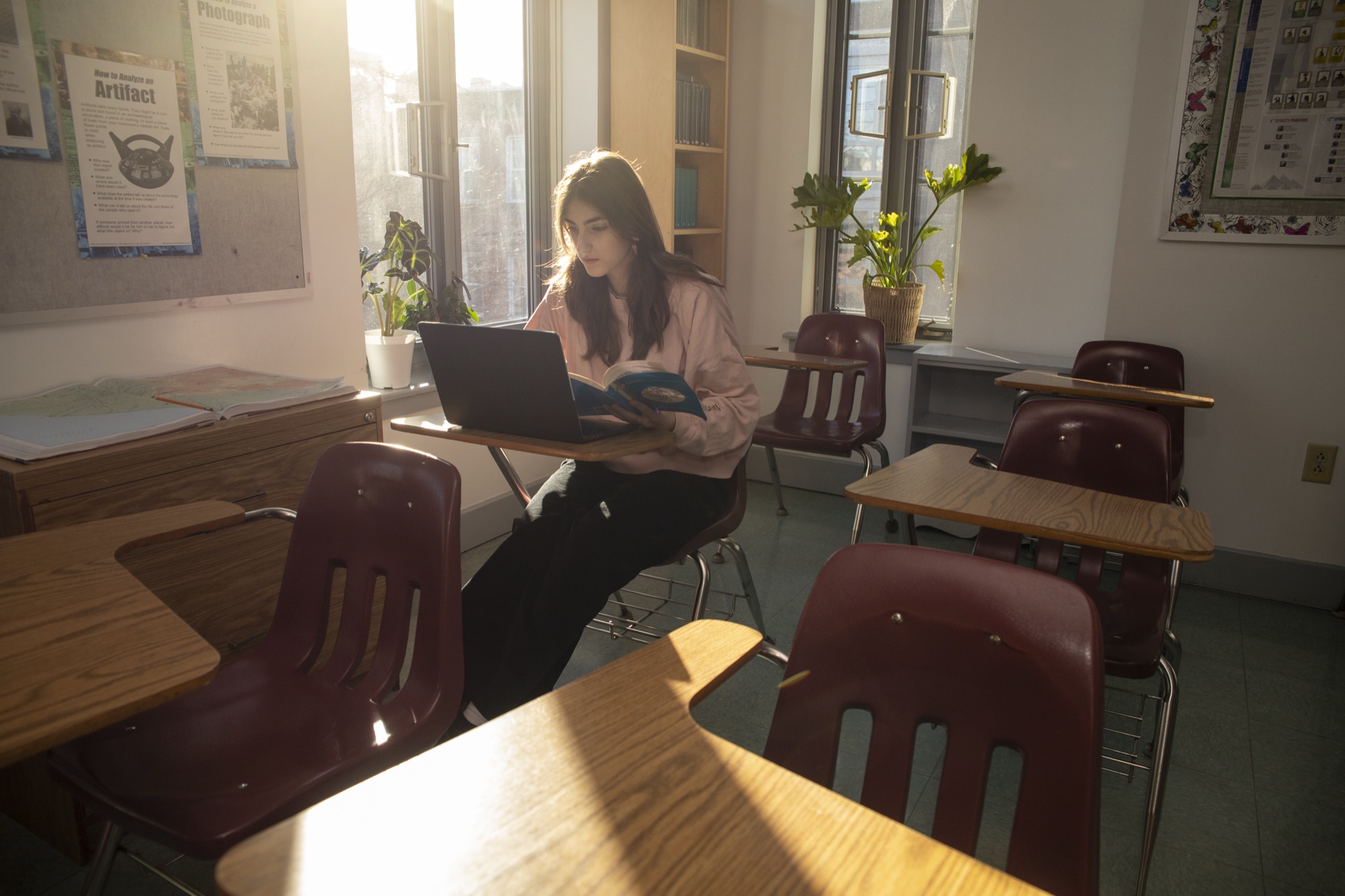 A Hudson School student at a desk in warm afternoon light