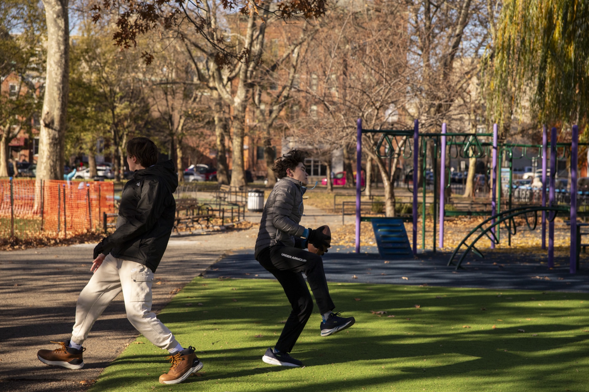 Children running and playing outdoors near Hoboken brownstones on an autumn day